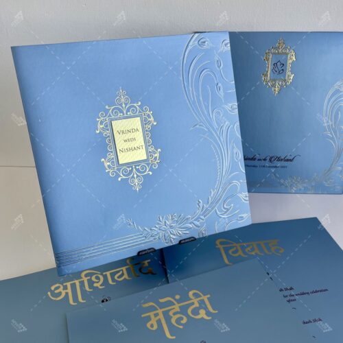 Icy Blue Card in Traditional Indian Design with Gold Foil on Emblem & Florals Golden Acrylic Nameplate for couple names in Silk Feel Paper